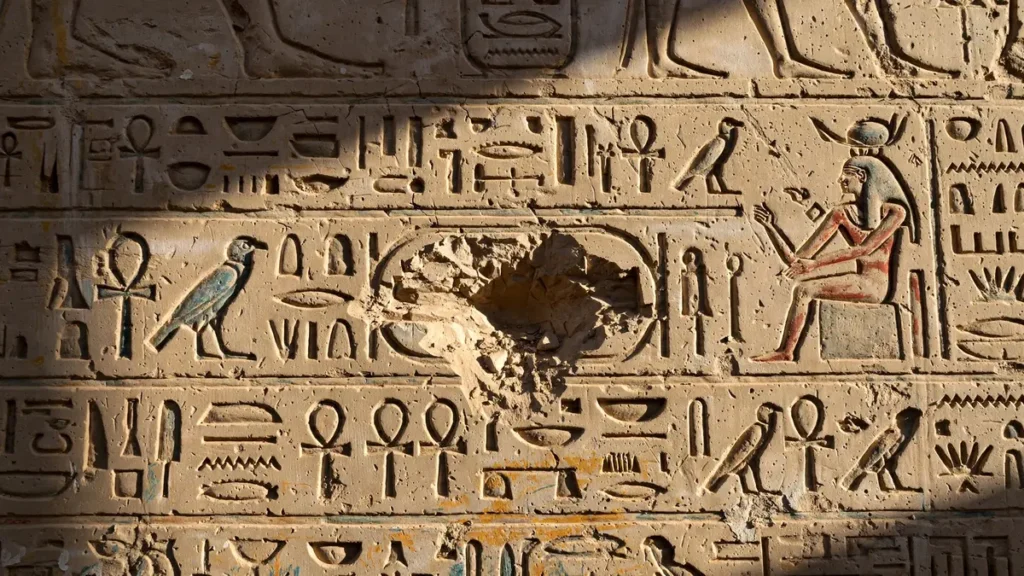 Carved temple wall with a royal cartouche deliberately chiselled away